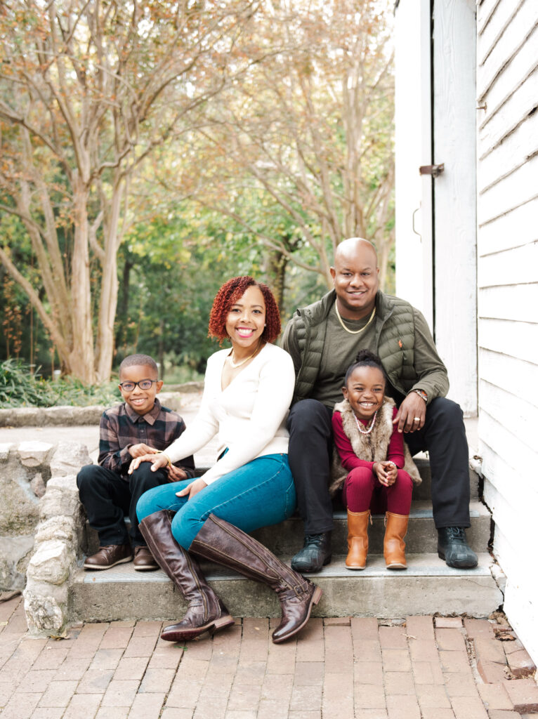 A Family having a fall portrait taken on stone stairs.